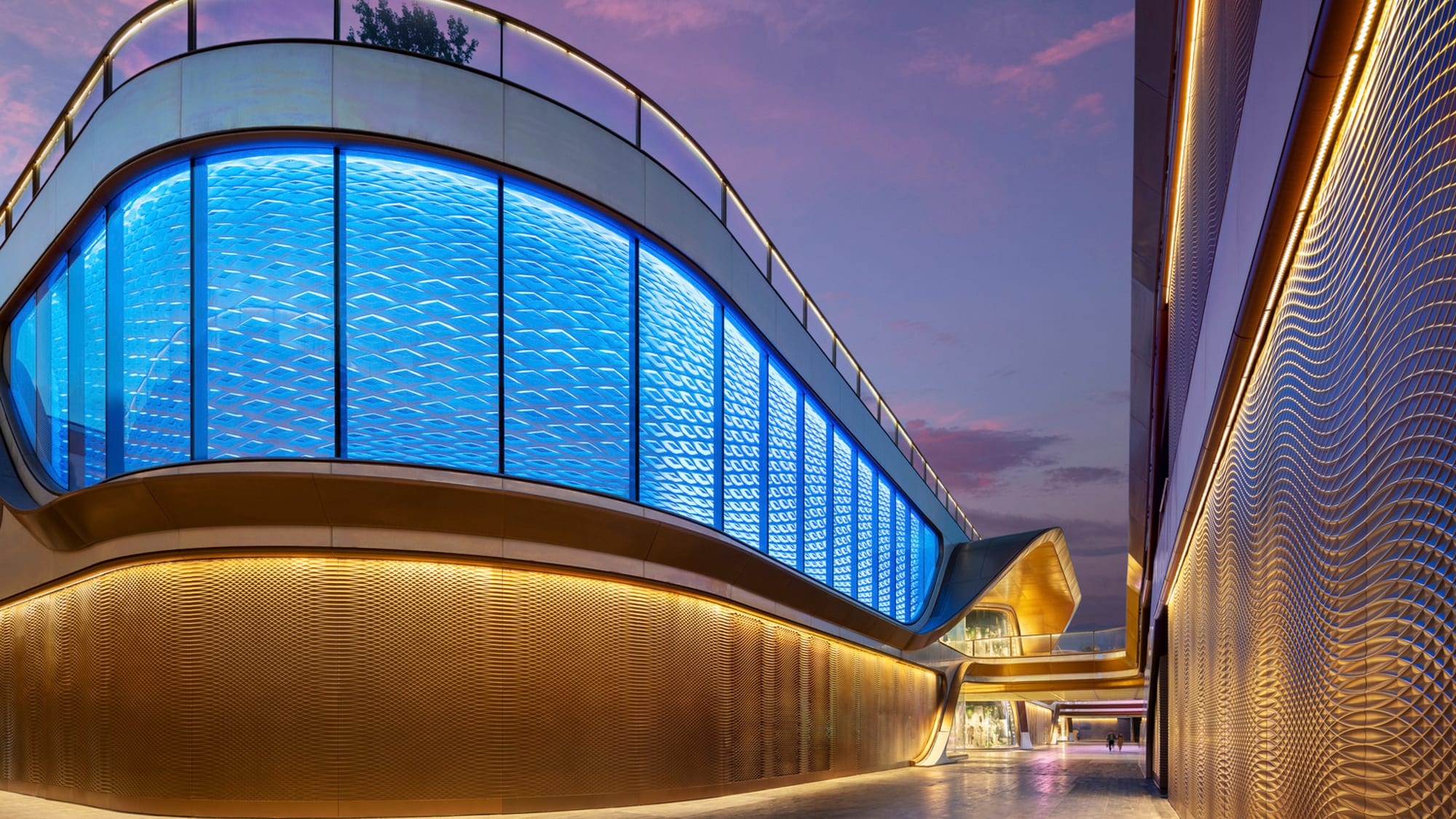 An illuminated diamond-patterned GRG back wall, its complex geometry brought into Revit families using BEAM.